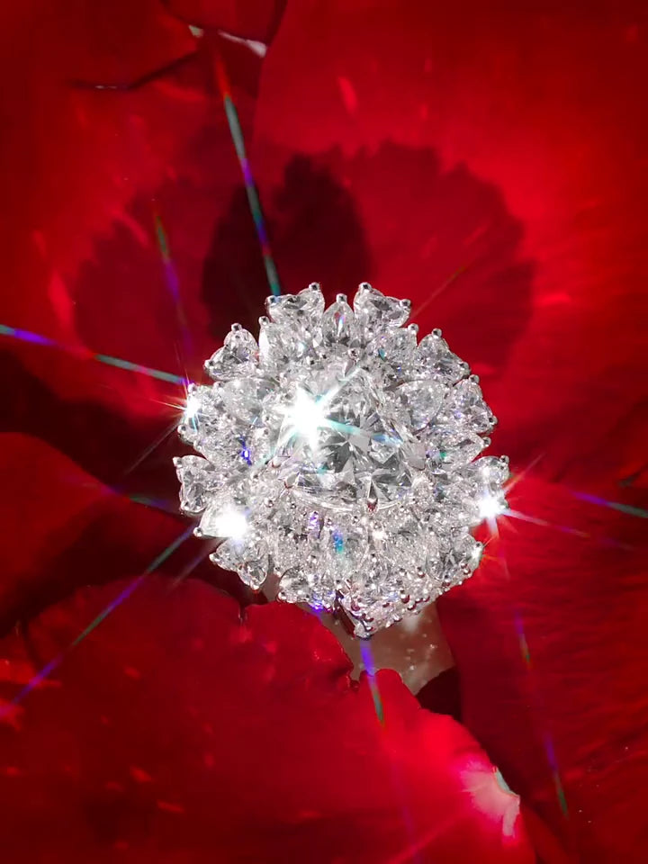 The VOBARA Flower Ring among red rose petals